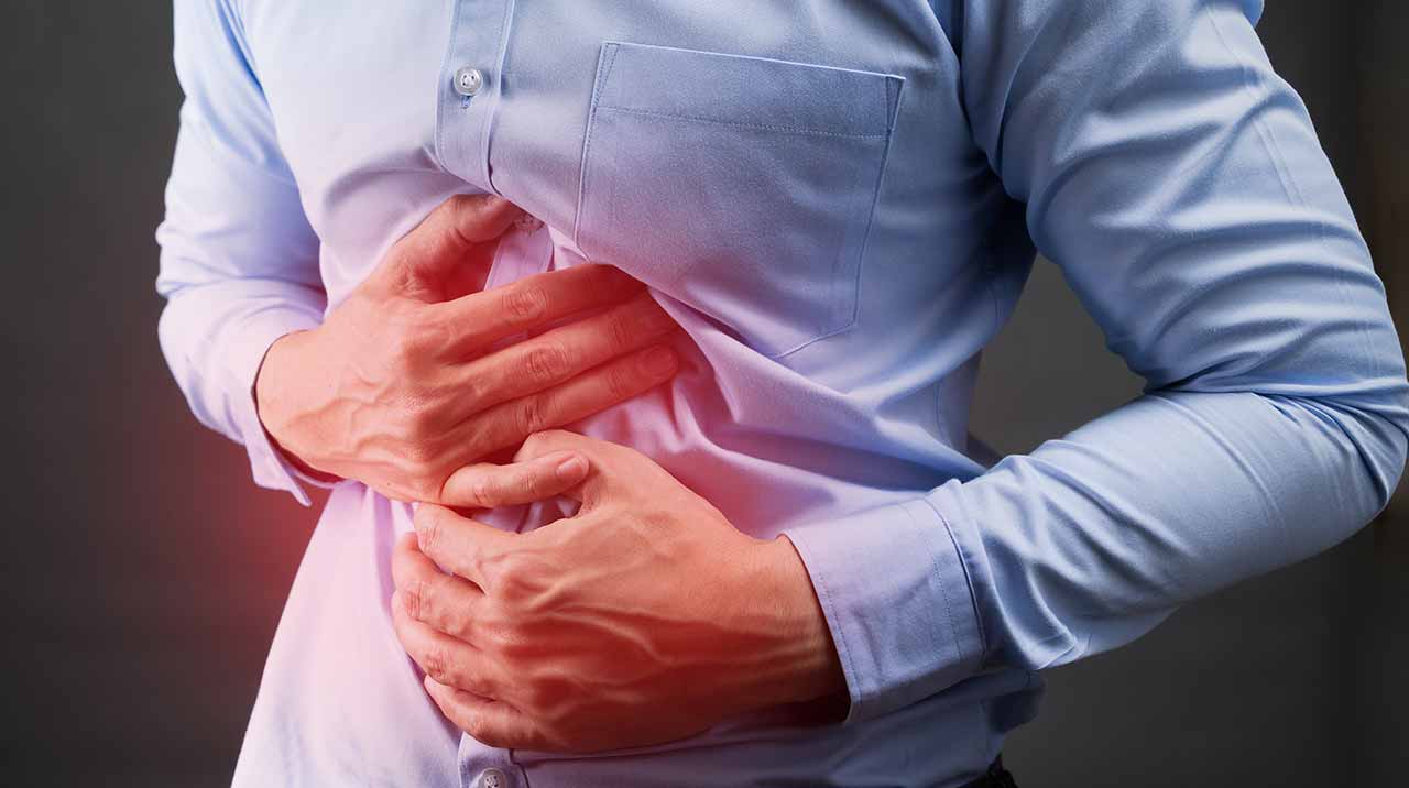 Man with digestive health problems holding his stomach.